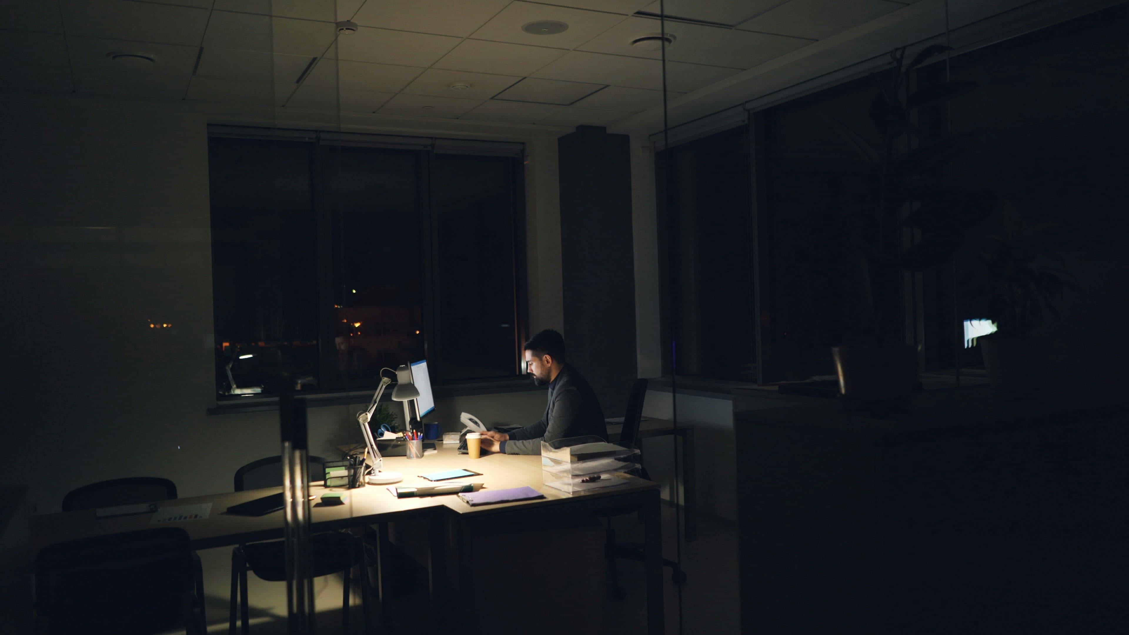 A professional taking a quiet moment during a long workday